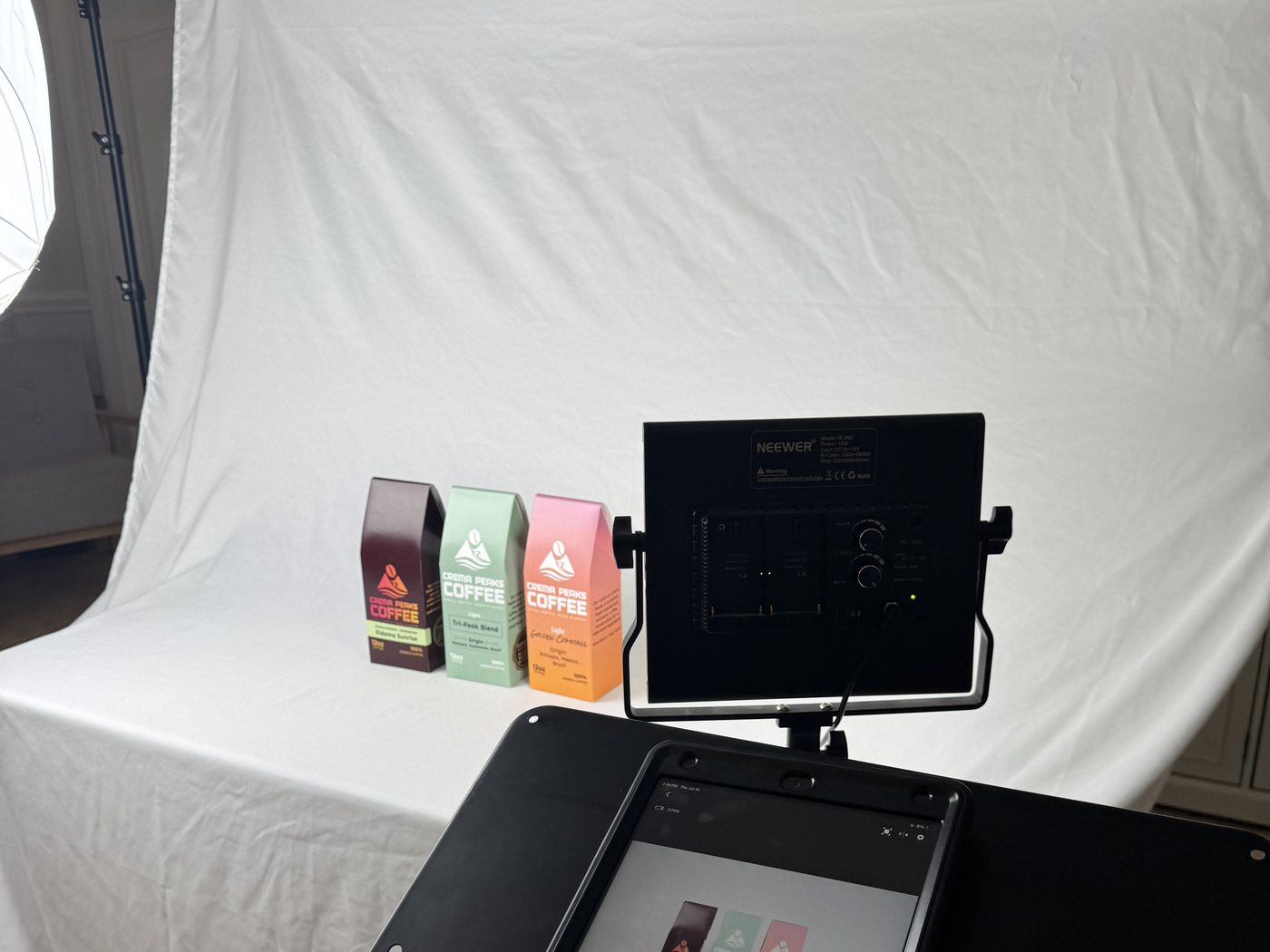 Behind the scenes at a Southern Exposure product photography shoot, with studio lighting and a backdrop set up for Crema Peaks Coffee